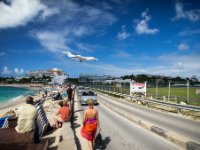 Another view of Maho Beach showing the road that passes between the beach and the end of the runway. When it&#39;s busy both lanes are full and people are walking on the sides of the road. As you can see the road isn&#39;t too wide so there isn&#39;t much room for traffic and pedestrians at the same time, especially if a bus or truck comes by.